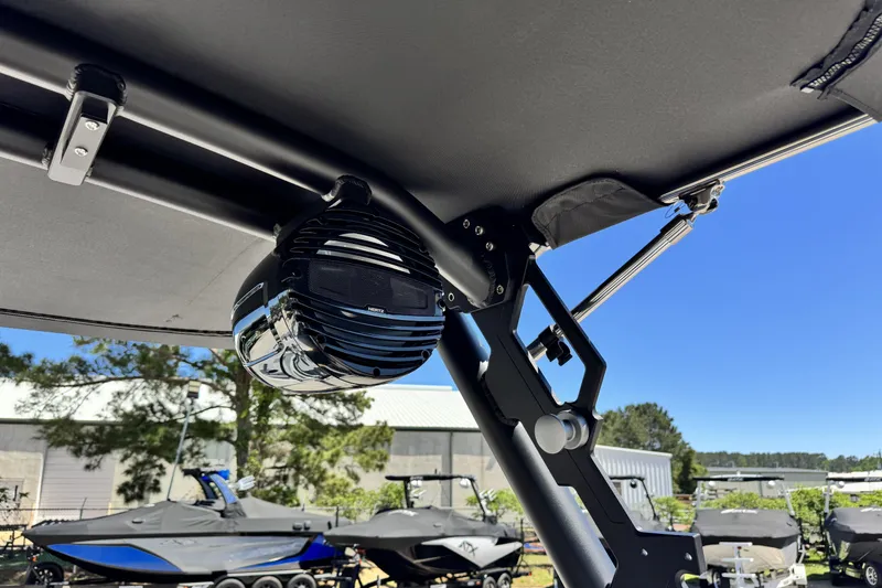 Slide: The Image of 2026 ATX Surf Boats 22 Type-S with mounted speaker under canopy, sunny day. - 12