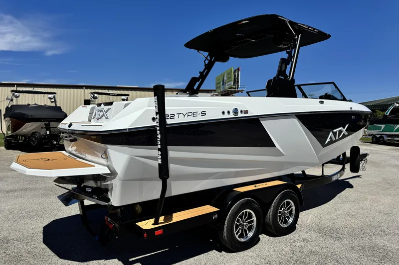 Slide: The Image of 2026 ATX Surf Boats 22 Type-S on trailer, sleek design, outdoor display. - 2