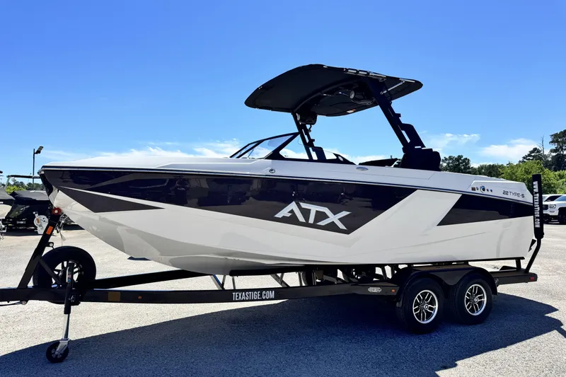 Slide: The Image of 2026 ATX Surf Boats 22 Type-S on trailer, sleek design under clear blue sky. - 4