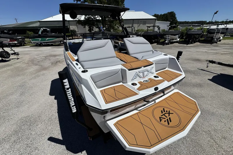 Slide: The Image of 2026 ATX Surf Boats 22 Type-S with sleek design and spacious seating in a marina setting. - 5