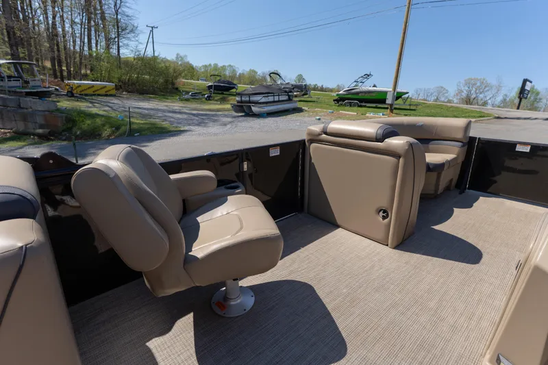 Slide: The Image of Interior of 2025 Starcraft EXS 3 boat with beige seating and outdoor view. - 10
