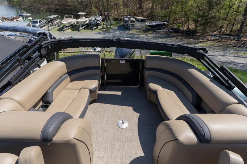 Slide: The Image of Luxurious seating on 2025 Starcraft EXS 3 boat, docked near a scenic lake. - 12