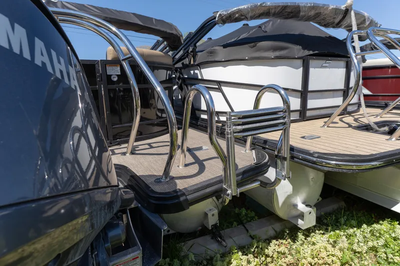 Slide: The Image of 2025 Starcraft EXS 3 pontoon boat with chrome railings and Yamaha engine. - 2