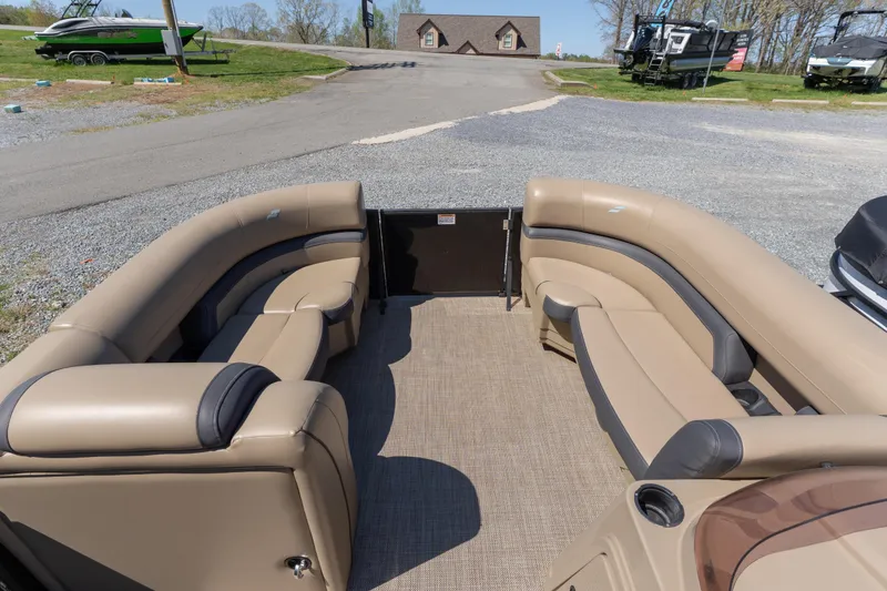 Slide: The Image of Luxurious seating on a 2025 Starcraft EXS 3 pontoon boat, parked outdoors. - 3