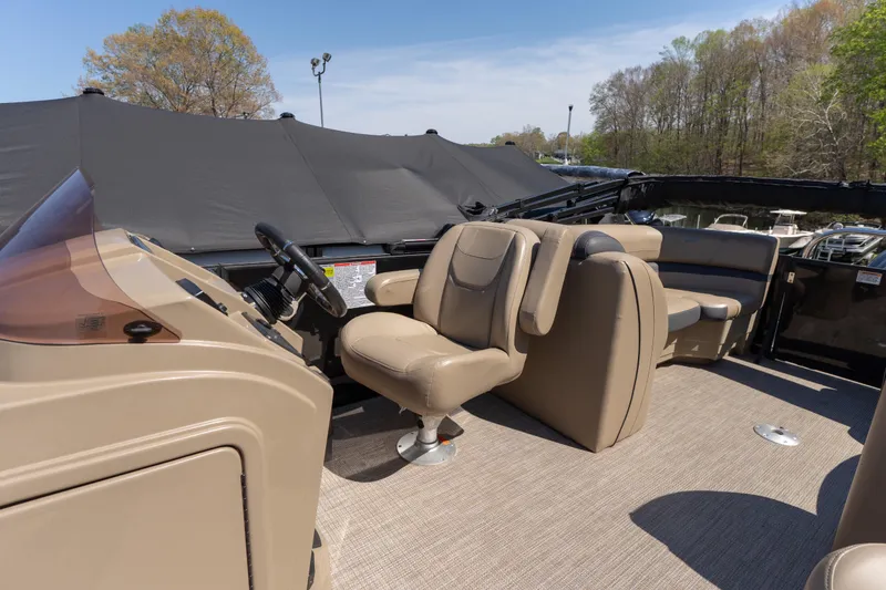 Slide: The Image of 2025 Starcraft EXS 3 boat interior with beige seating and steering console. - 5