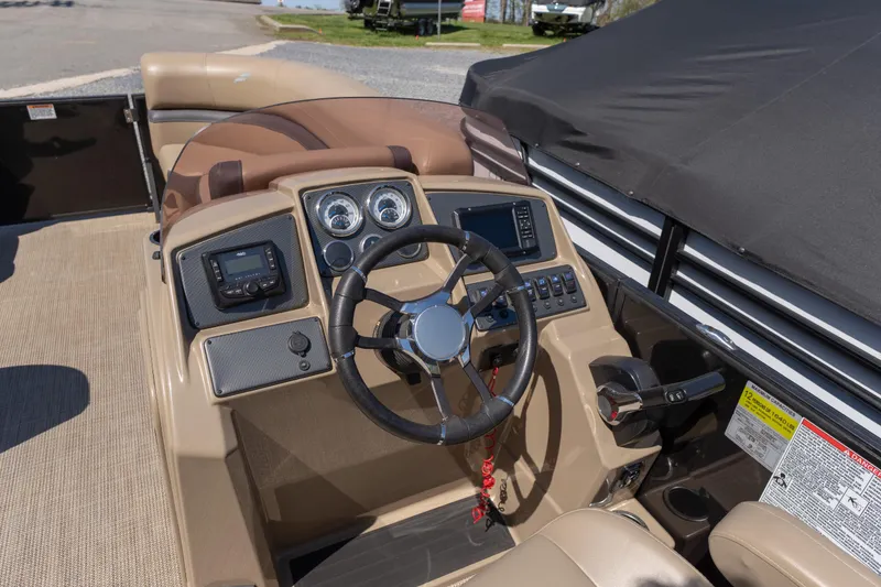 Slide: The Image of Interior view of 2025 Starcraft EXS 3 boat dashboard with steering wheel and controls. - 6