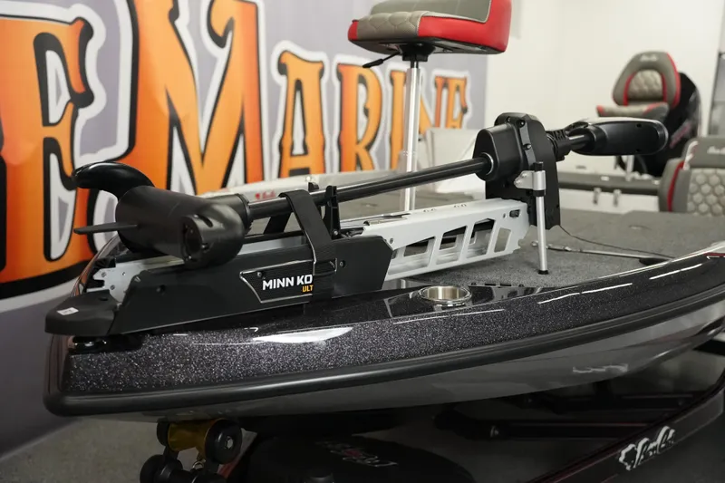 Slide: The Image of 2026 Bass Cat Lynx STS boat with Minn Kota trolling motor in showroom. - 11