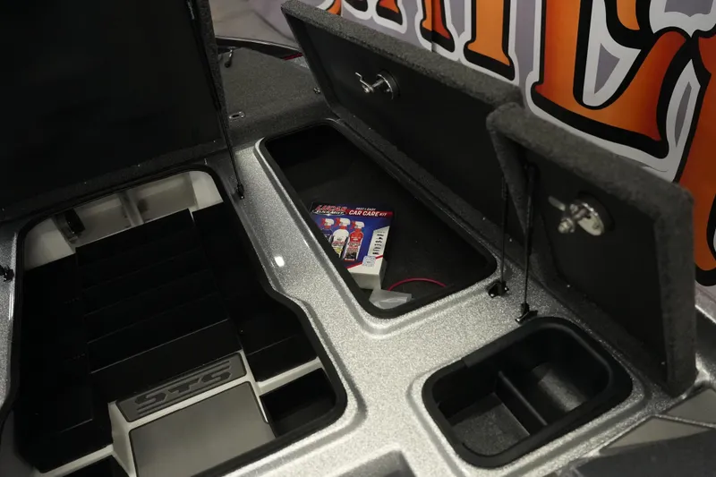 Slide: The Image of 2026 Bass Cat Lynx STS storage compartments with Lucas Oil care kit. - 18