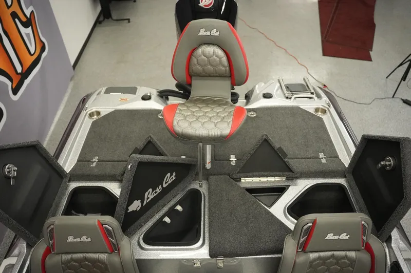 Slide: The Image of 2026 Bass Cat Lynx STS boat interior with open storage compartments and seating. - 20
