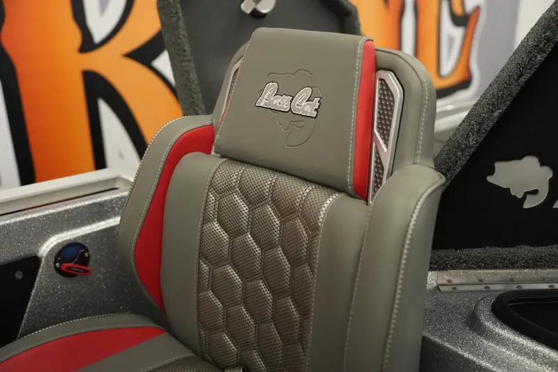 Slide: The Image of 2026 Bass Cat Lynx STS boat seat with gray and red upholstery. - 22
