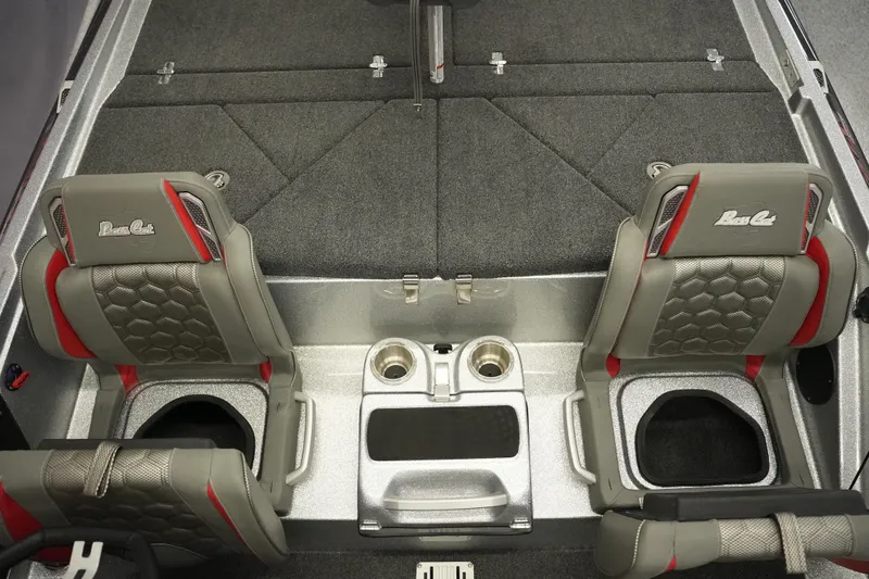Slide: The Image of 2026 Bass Cat Lynx STS interior with gray and red seats, cup holders, and carpeted flooring. - 25