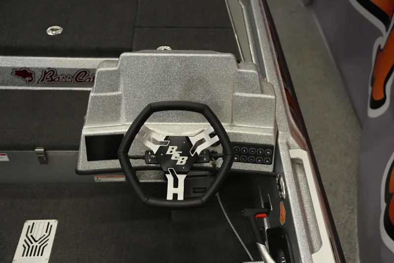 Slide: The Image of 2026 Bass Cat Lynx STS boat dashboard with steering wheel and control panel. - 28