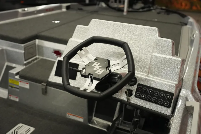 Slide: The Image of 2026 Bass Cat Lynx STS boat steering wheel and control panel, featuring sleek design. - 29