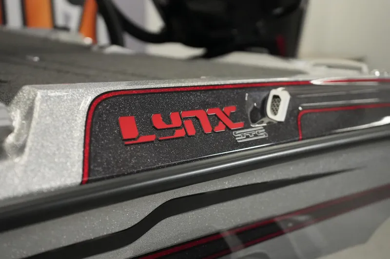 Slide: The Image of 2026 Bass Cat Lynx STS boat detail with red and silver accents. - 31