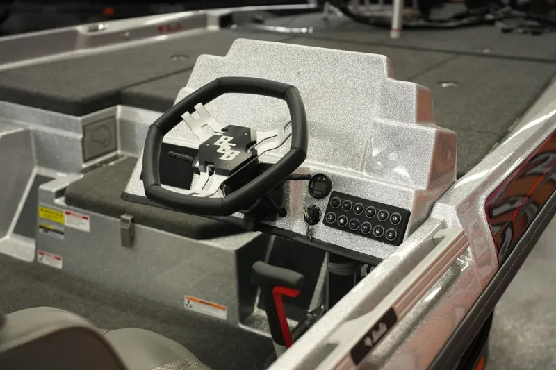 Slide: The Image of 2026 Bass Cat Lynx STS boat interior with steering wheel and control panel. - 7