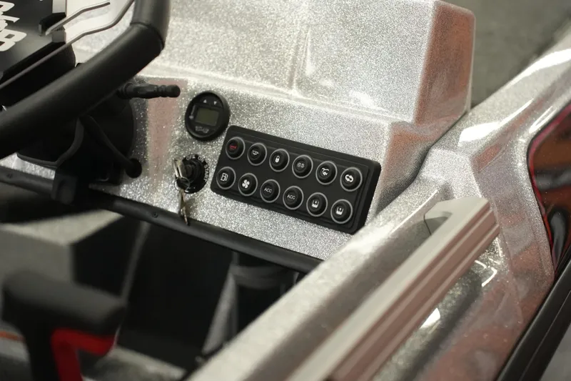 Slide: The Image of 2026 Bass Cat Lynx STS dashboard with control panel and ignition key. - 8