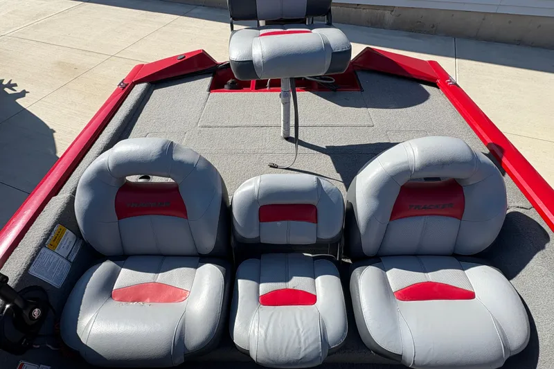 Slide: The Image of 2011 Tracker Pro Team 175 TXW boat seats with red and gray upholstery. - 12
