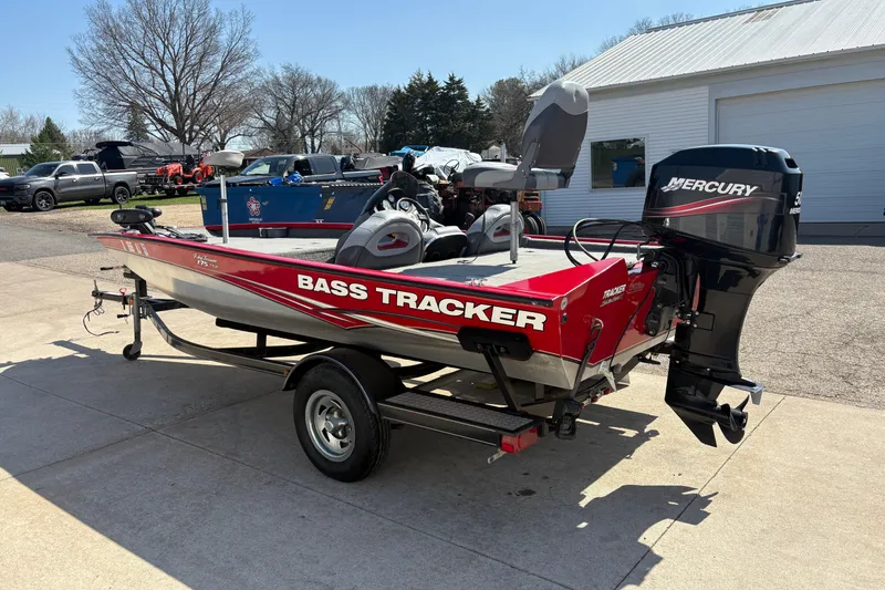 Slide: The Image of 2011 Tracker Pro Team 175 TXW bass boat with Mercury engine on trailer. - 4