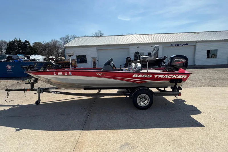 Slide: The Image of 2011 Tracker Pro Team 175 TXW bass boat on trailer outside showroom. - 5