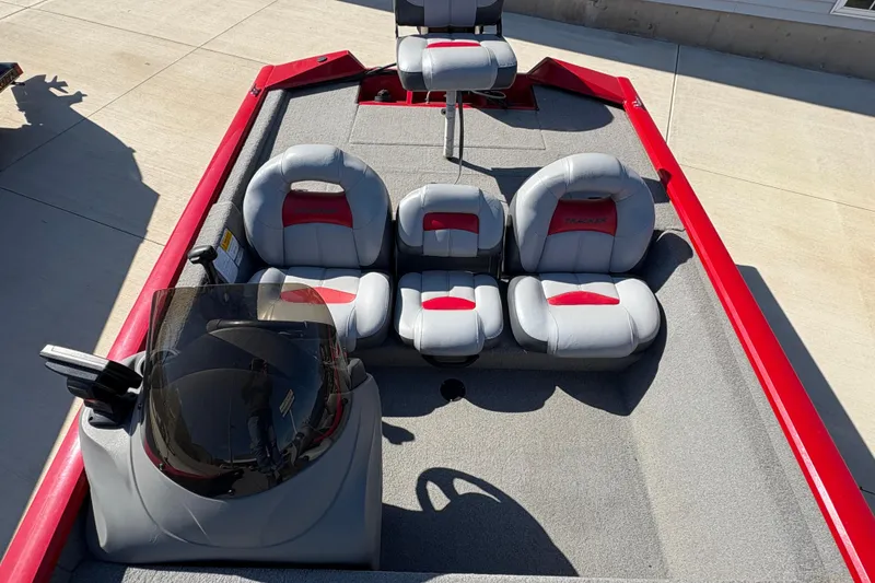 Slide: The Image of 2011 Tracker Pro Team 175 TXW boat interior with gray and red seating. - 9