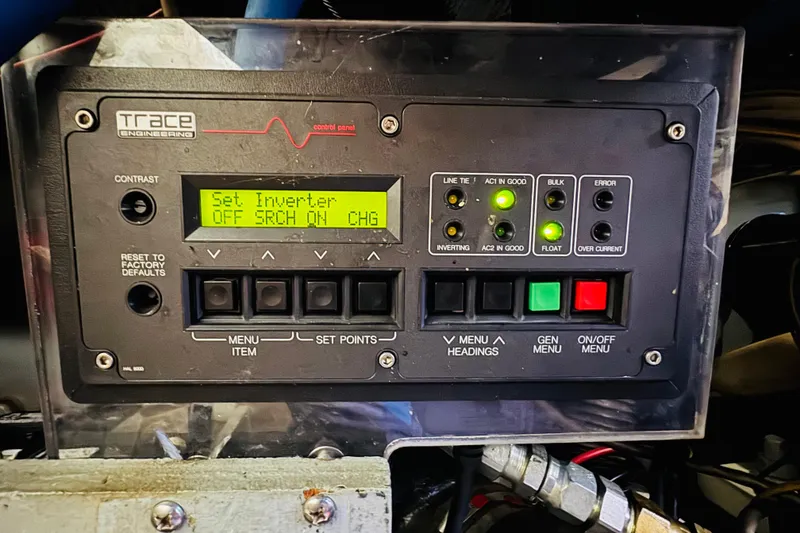 Slide: The Image of Control panel of a 1999 Sea Ray 400 Sedan Bridge boat, featuring inverter settings and indicators. - 103