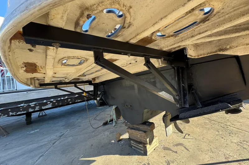 Slide: The Image of Underside view of a 1999 Sea Ray 400 Sedan Bridge boat on blocks. - 107