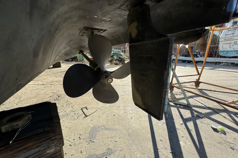 Slide: The Image of Propeller and rudder of a 1999 Sea Ray 400 Sedan Bridge boat on dry dock. - 108