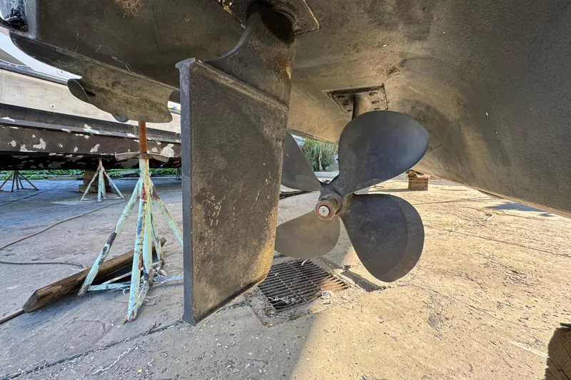 Slide: The Image of Propeller and rudder of a 1999 Sea Ray 400 Sedan Bridge on dry dock. - 109