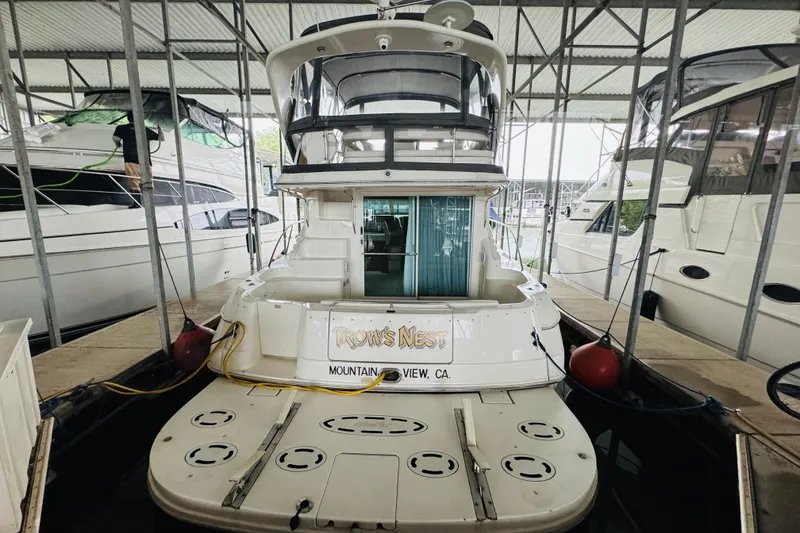 Slide: The Image of 1999 Sea Ray 400 Sedan Bridge docked in a marina, rear view. - 16