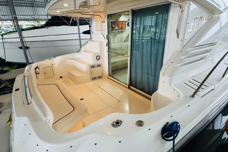Slide: The Image of 1999 Sea Ray 400 Sedan Bridge yacht interior with seating and sliding glass door. - 20
