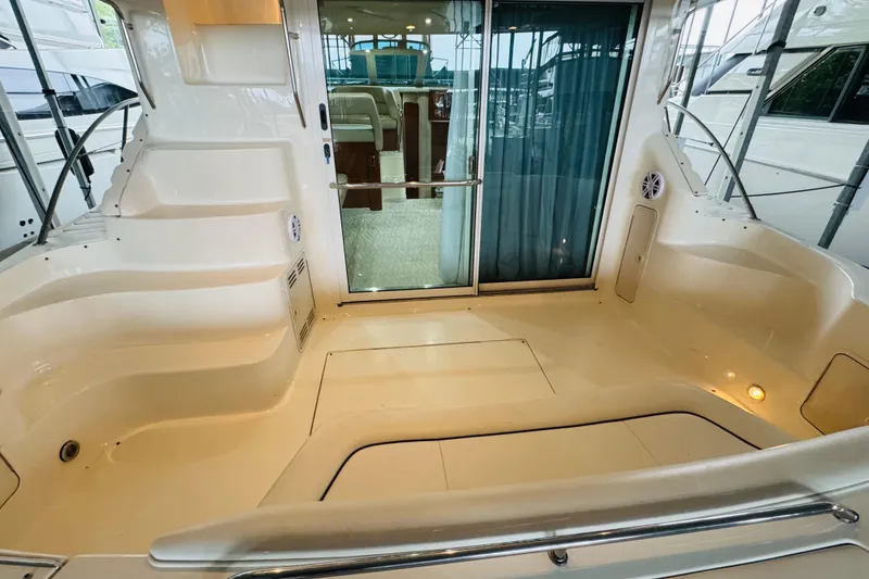 Slide: The Image of 1999 Sea Ray 400 Sedan Bridge yacht interior with spacious seating and sliding glass door. - 21