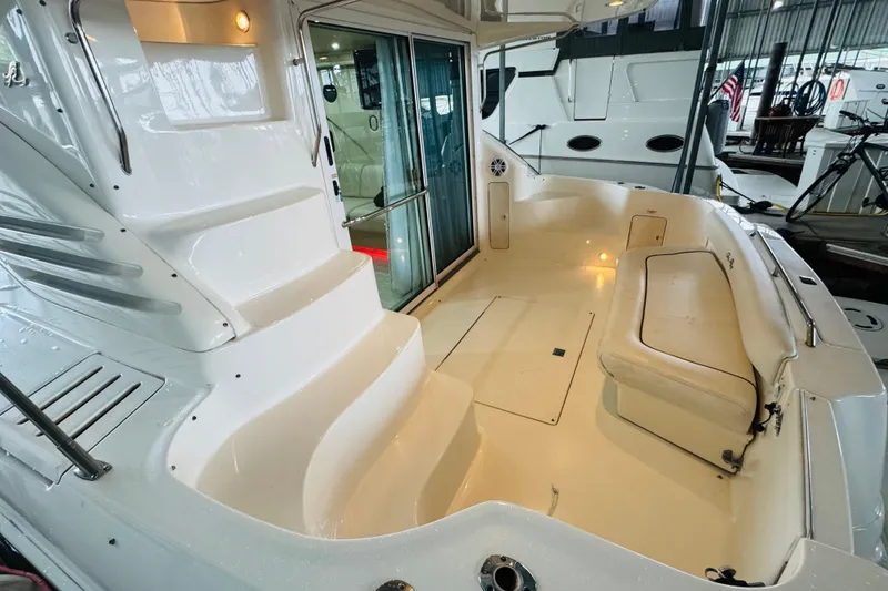 Slide: The Image of 1999 Sea Ray 400 Sedan Bridge yacht interior with seating and stairs, showcasing luxury design. - 22