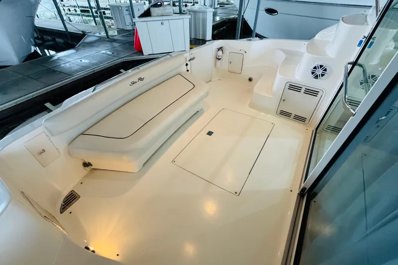 Slide: The Image of 1999 Sea Ray 400 Sedan Bridge boat deck with seating and storage compartments. - 24