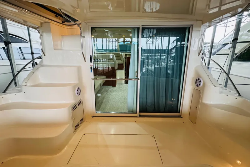 Slide: The Image of 1999 Sea Ray 400 Sedan Bridge yacht interior with sliding glass door and steps. - 25