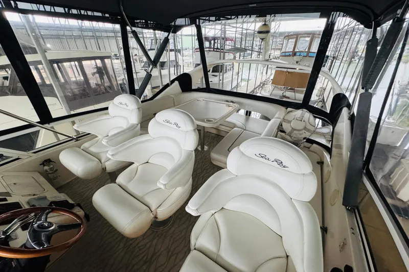 Slide: The Image of 1999 Sea Ray 400 Sedan Bridge interior with white leather seating and steering wheel. - 28