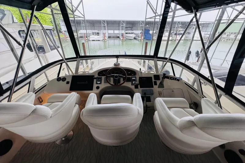 Slide: The Image of Interior view of 1999 Sea Ray 400 Sedan Bridge yacht cockpit with white leather seats. - 31