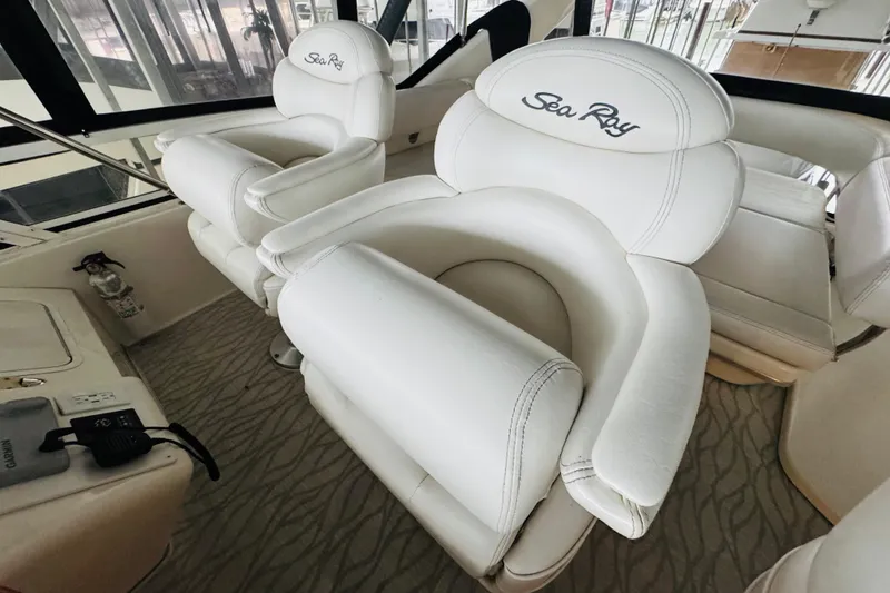 Slide: The Image of Luxurious white seating on 1999 Sea Ray 400 Sedan Bridge yacht interior. - 33