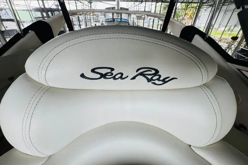 Slide: The Image of 1999 Sea Ray 400 Sedan Bridge boat seat with logo in marina setting. - 34