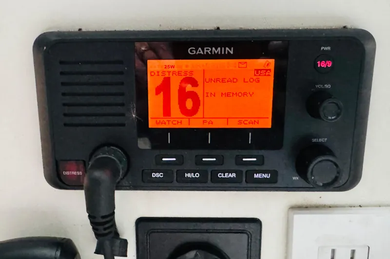 Slide: The Image of Garmin marine radio on 1999 Sea Ray 400 Sedan Bridge, displaying channel 16 distress signal. - 53