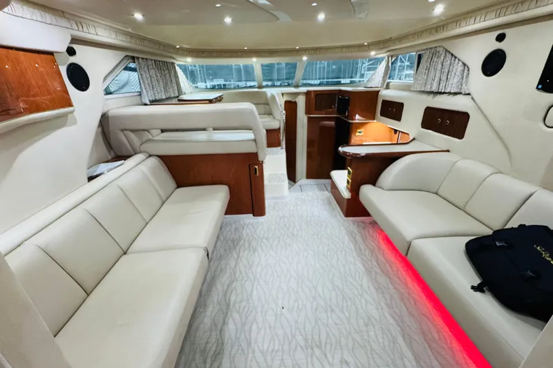Slide: The Image of Luxurious interior of a 1999 Sea Ray 400 Sedan Bridge yacht with elegant seating and ambient lighting. - 56