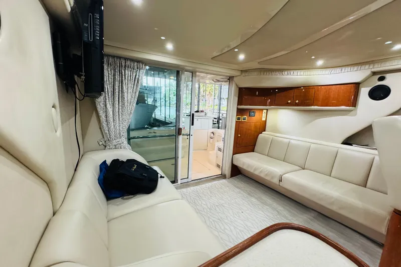 Slide: The Image of Luxurious interior of a 1999 Sea Ray 400 Sedan Bridge yacht with plush seating. - 61