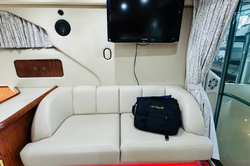 Slide: The Image of Interior of 1999 Sea Ray 400 Sedan Bridge with sofa, TV, and bag. - 63