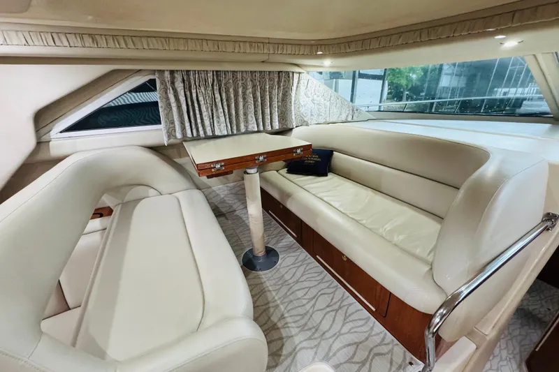Slide: The Image of Luxurious interior of 1999 Sea Ray 400 Sedan Bridge with elegant seating and table. - 66