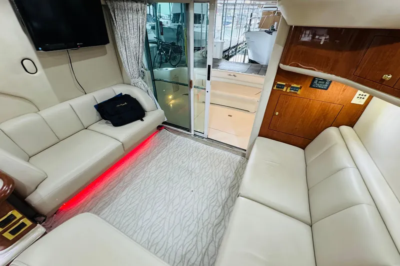 Slide: The Image of Interior of 1999 Sea Ray 400 Sedan Bridge yacht with white leather seating and modern amenities. - 67