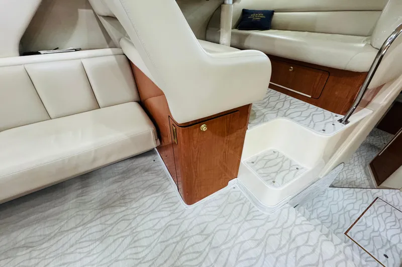 Slide: The Image of Interior of 1999 Sea Ray 400 Sedan Bridge with beige seating and wood accents. - 68