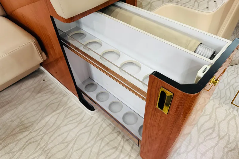 Slide: The Image of 1999 Sea Ray 400 Sedan Bridge interior with built-in cup holder storage. - 69