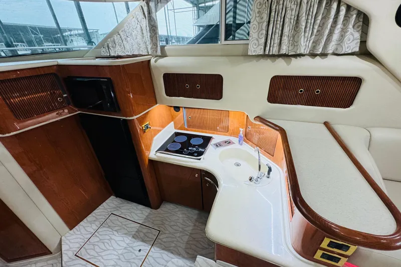 Slide: The Image of Interior of 1999 Sea Ray 400 Sedan Bridge yacht kitchen with stove and sink. - 70