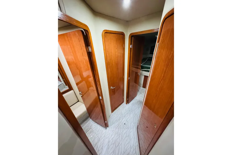 Slide: The Image of Interior hallway of 1999 Sea Ray 400 Sedan Bridge with wooden doors and modern design. - 77
