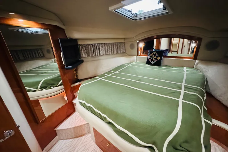 Slide: The Image of Luxurious 1999 Sea Ray 400 Sedan Bridge cabin with green bedding and modern amenities. - 79