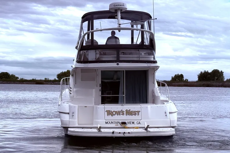 Slide: The Image of 1999 Sea Ray 400 Sedan Bridge yacht on calm water, rear view. - 8